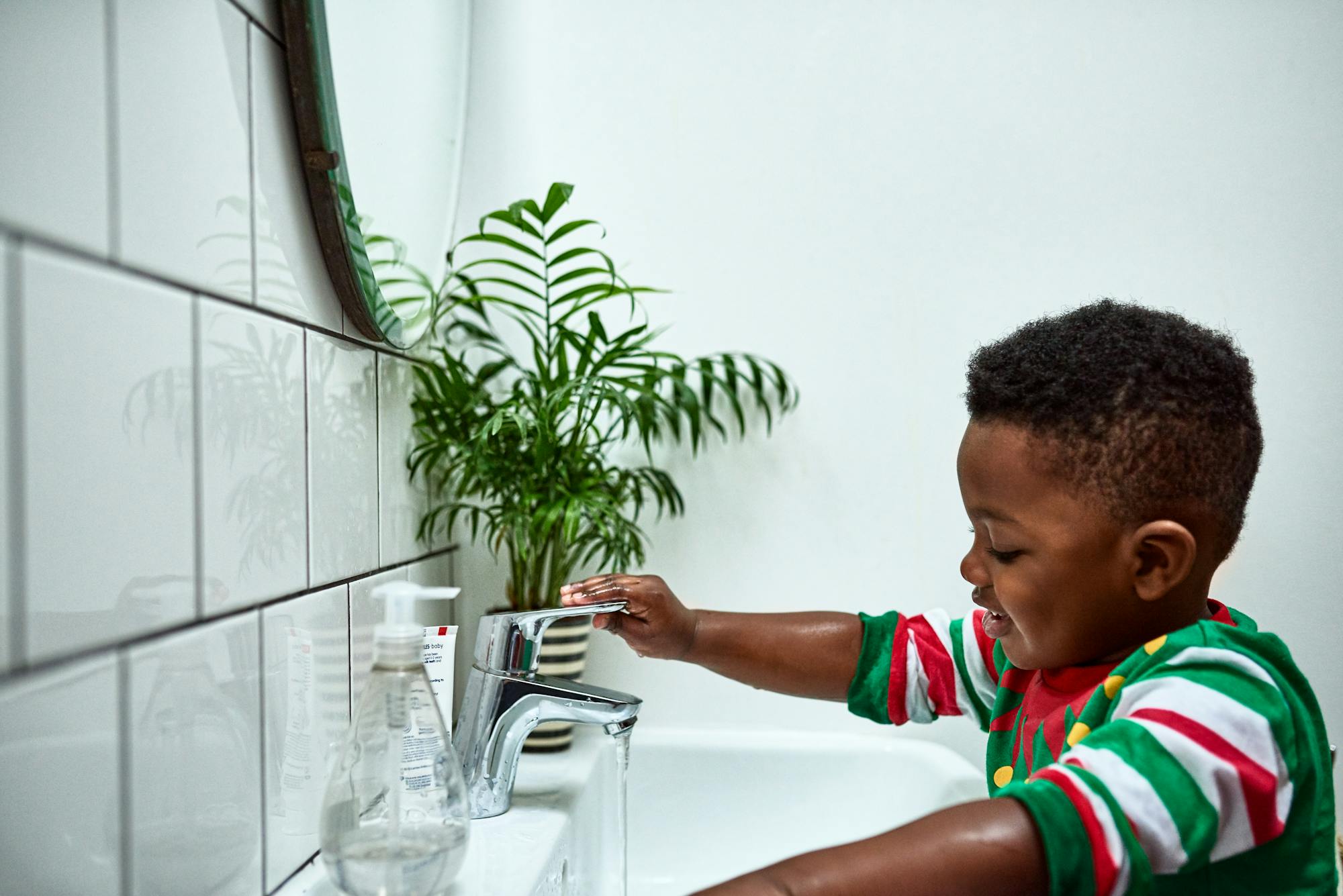 Letting 2-year-olds do simple tasks on their own, like washing their hands, can help reaffirm their growing independence.