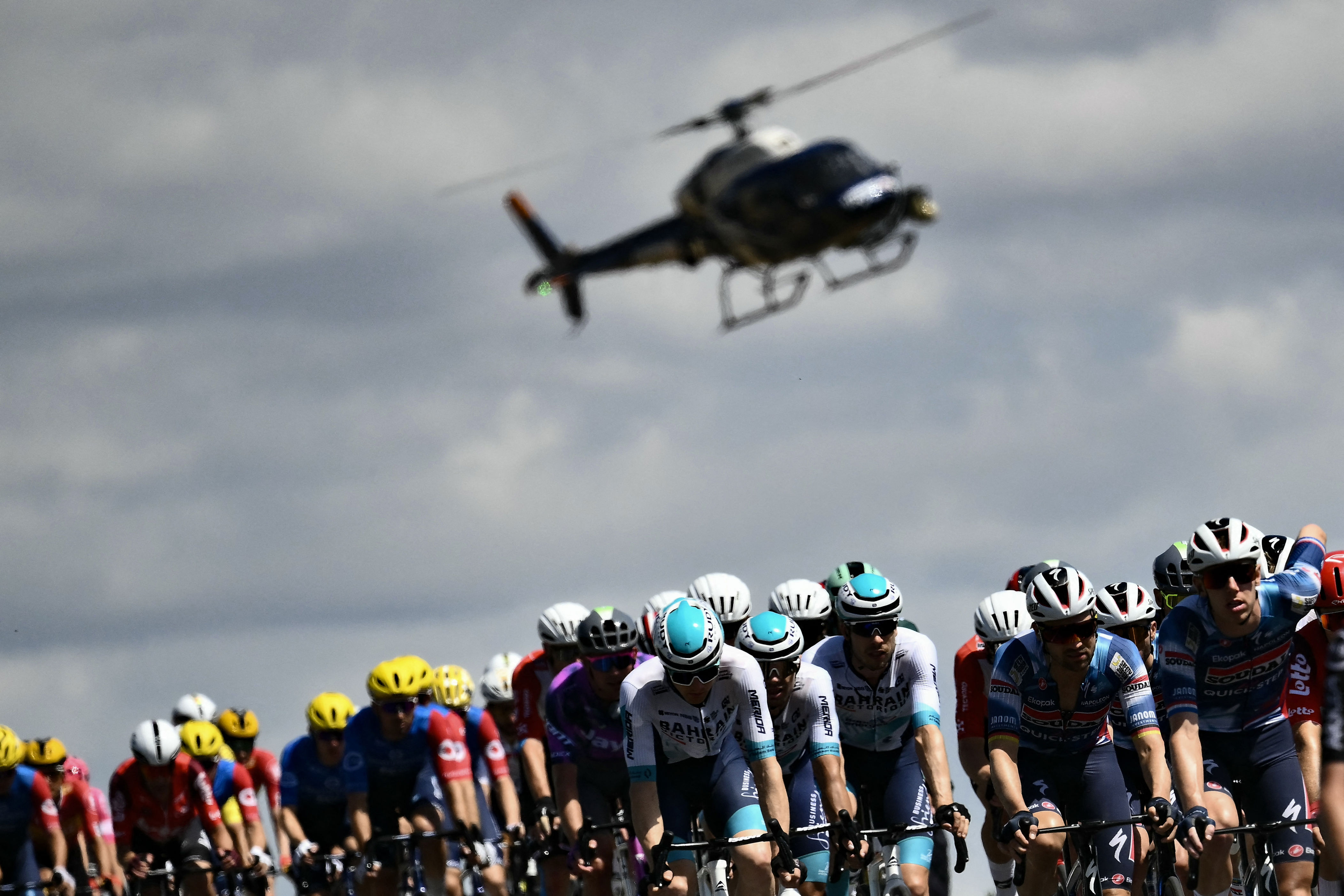 Tour de France peloton in 2025 with helipcopter in background