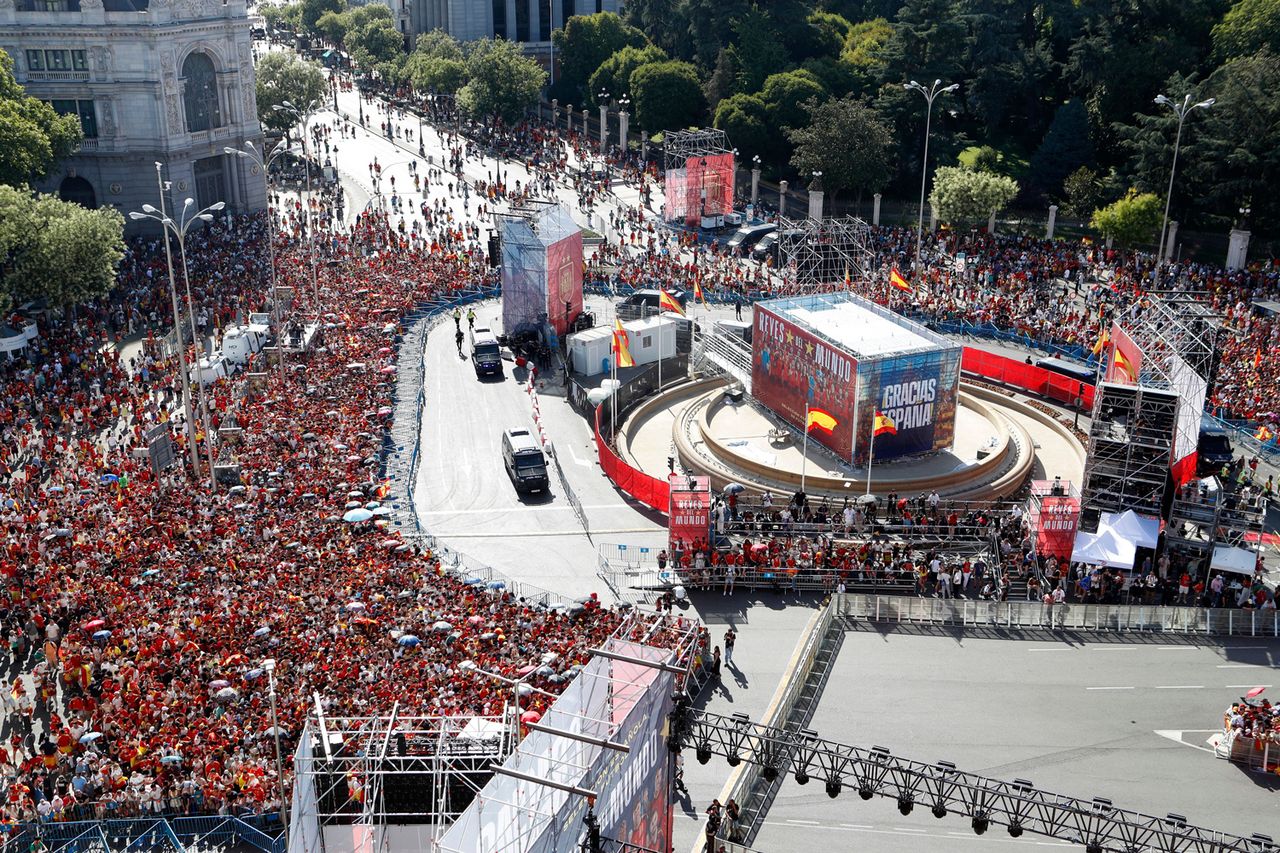 Aerial view from the observation deck of the Palacio de Cibeles as a massive, euphoric crowd of Spanish soccer fans fills the iconic Plaza de Cibeles hours before the arrival of the national team to celebrate their 2026 World Cup 1-0 victory over Argentina.