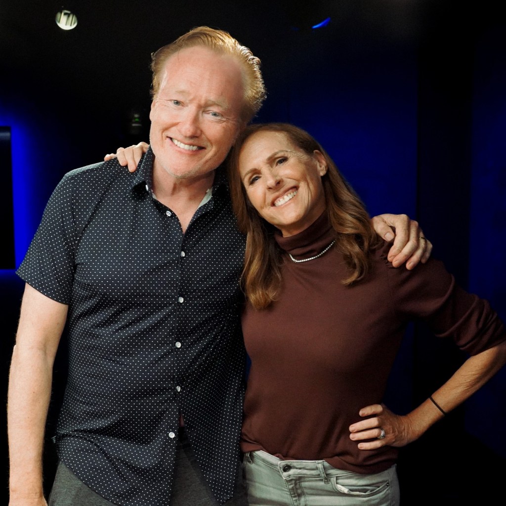 Conan O'Brien and Molly Shannon smiling.