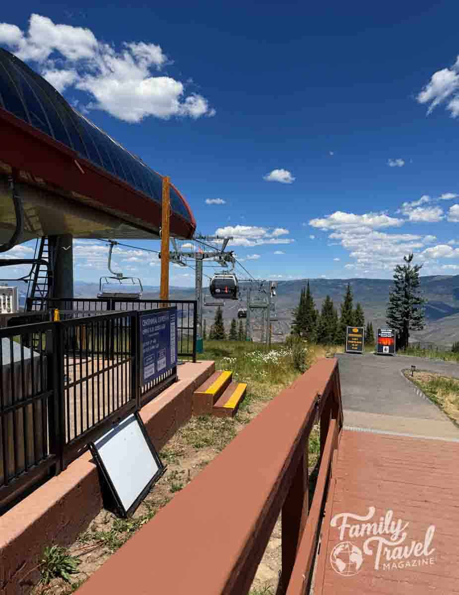 Centennial Express gondola and chairlifts at Beaver Creek Resort, Colorado, with scenic mountains under a blue sky.