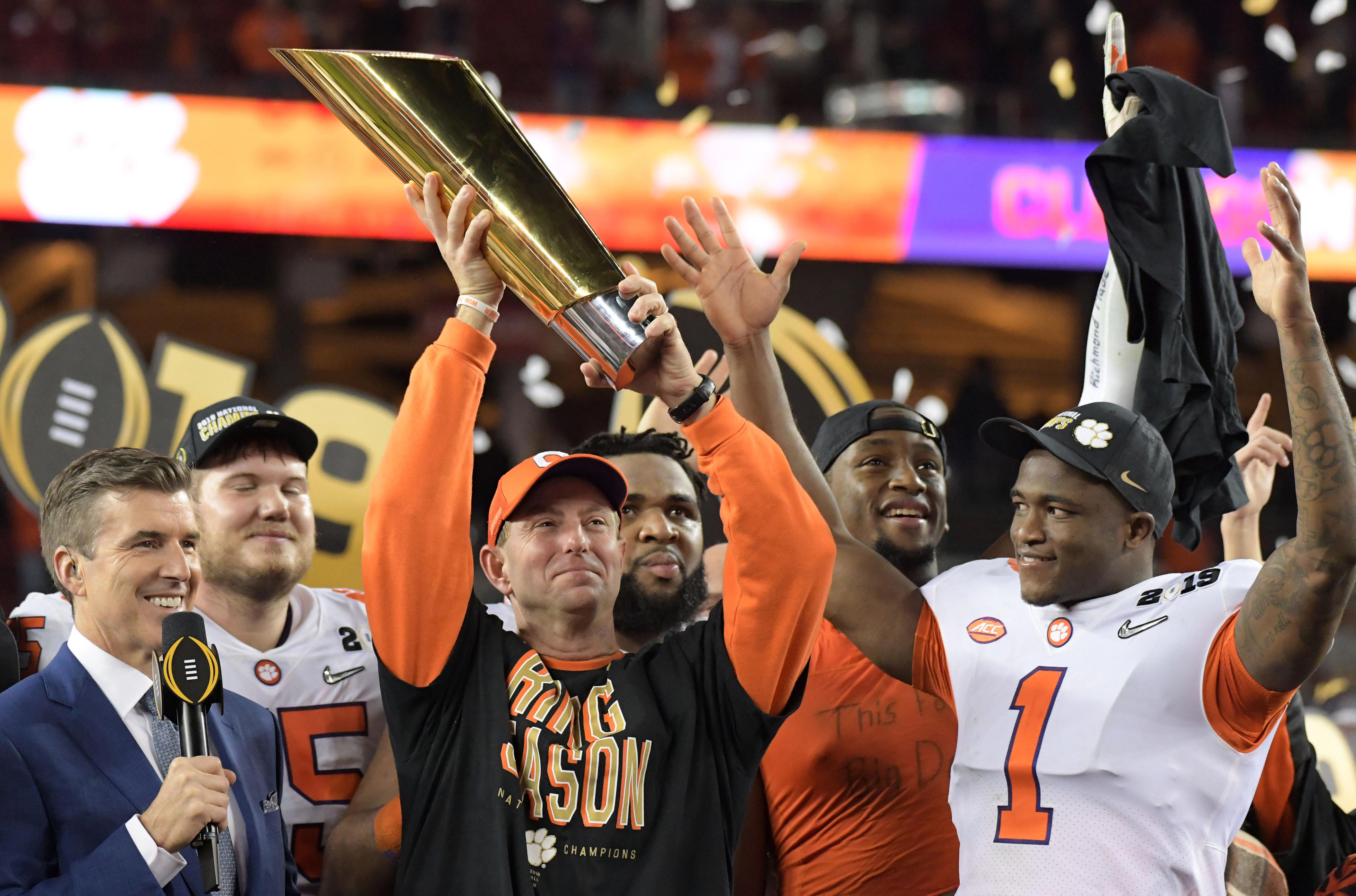 Jan 7, 2019; Santa Clara, CA, USA; Clemson Tigers head coach Dabo Swinney celebrates with the College Football Playoff National Championship trophy on the podium after defeating the Alabama Crimson Tide in the 2019 College Football Playoff Championship game at Levi's Stadium. Mandatory Credit: Kirby Lee-USA TODAY Sports