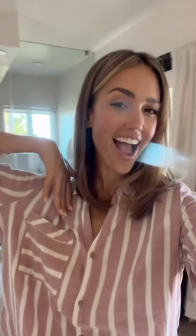 Jessica Alba with short hair in a striped shirt