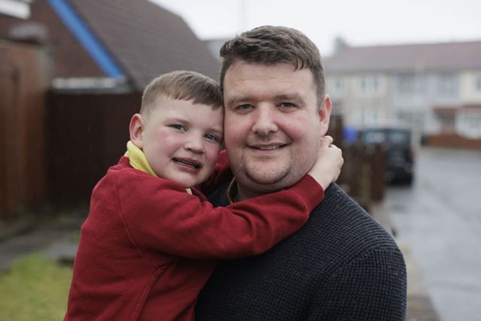 Mairtin Mac Gabhann with Daithi at their home in west Belfast (Liam McBurney/PA) (PA Archive/PA Images - Liam McBurney)