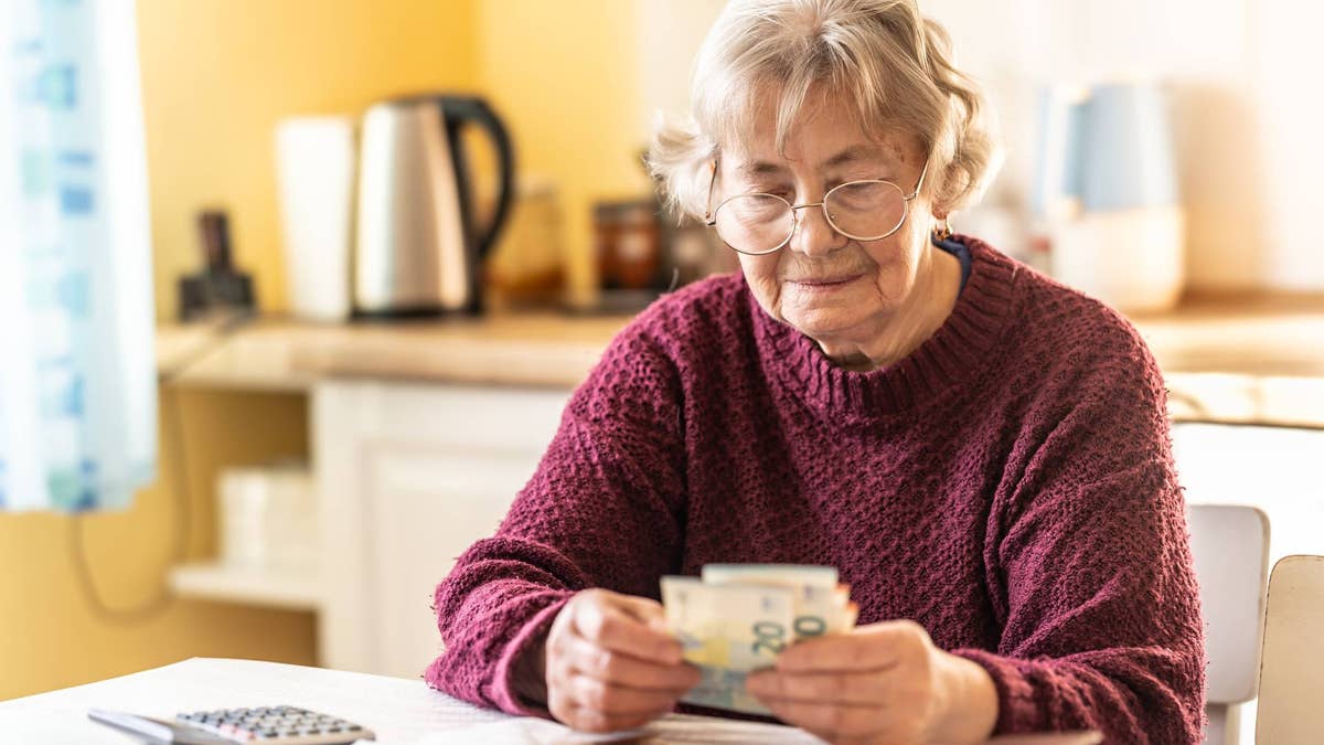 retired-woman-with-cash-at-home