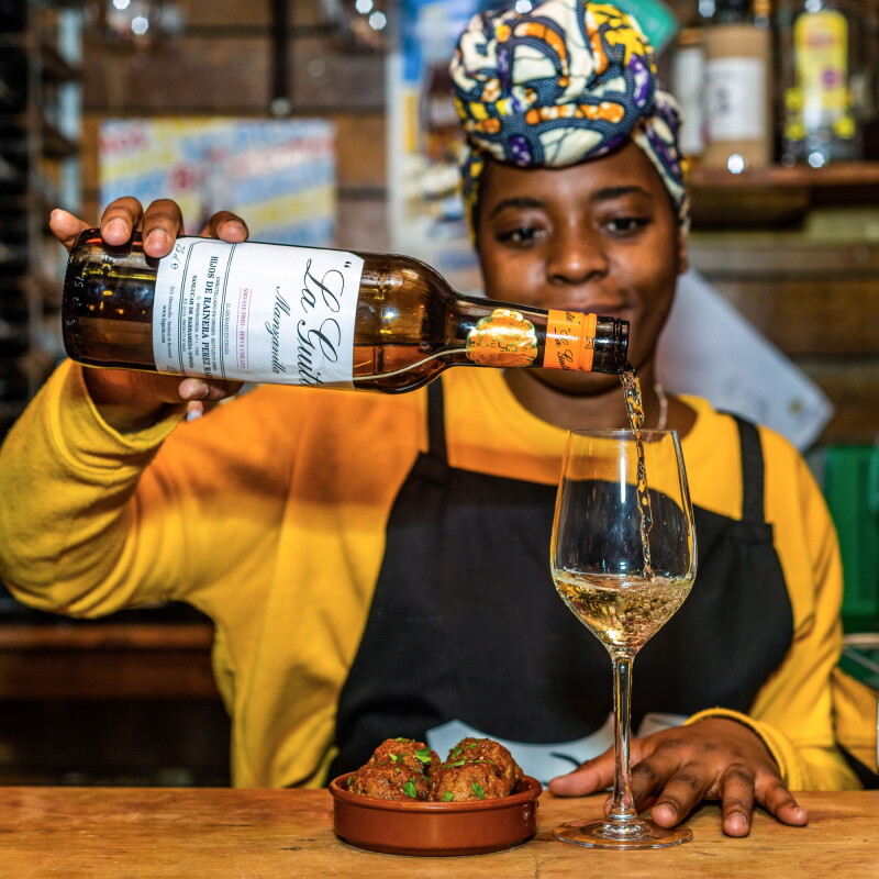 Waitress pouring glass of wine