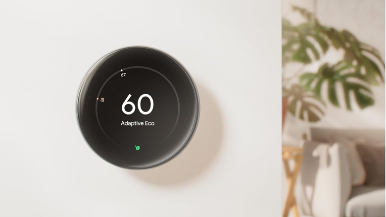 A Google Nest Learning Thermostat 4th gen on a wall in a home, showing Adaptive Eco mode active