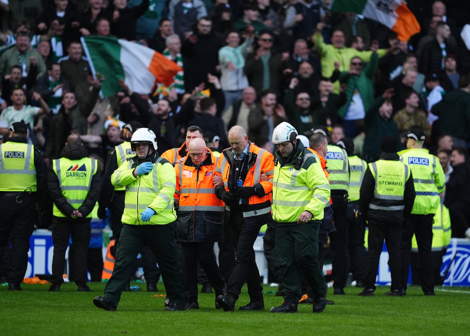 Medics support a steward during the Ibrox trouble