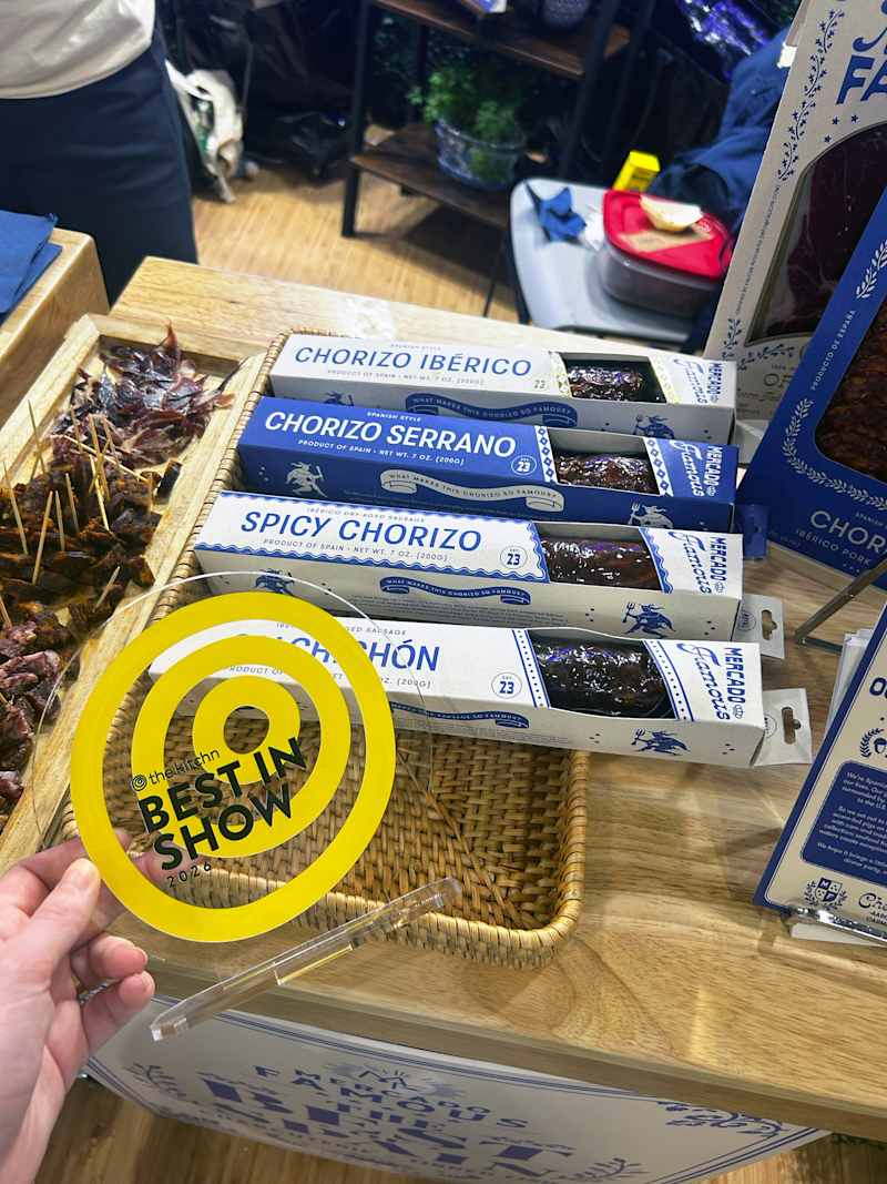 Chorizo products displayed on a wooden table with a yellow