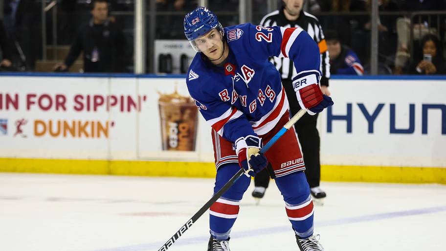 New York Rangers defenseman Adam Fox shooting the puck