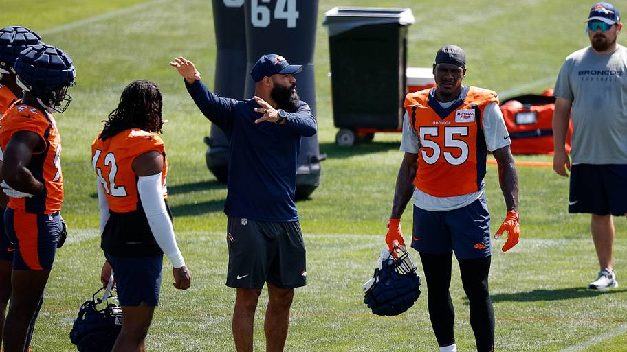 Jul 28, 2023; Englewood, CO, USA; Denver Broncos outside linebackers coach Michael Wilhoite talks with linebacker Nik Bonitto