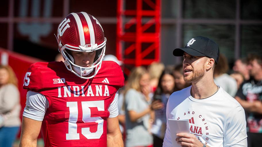 Indiana's Fernando Mendoza (15) speaks with quarterback coach Chandler Whitmer