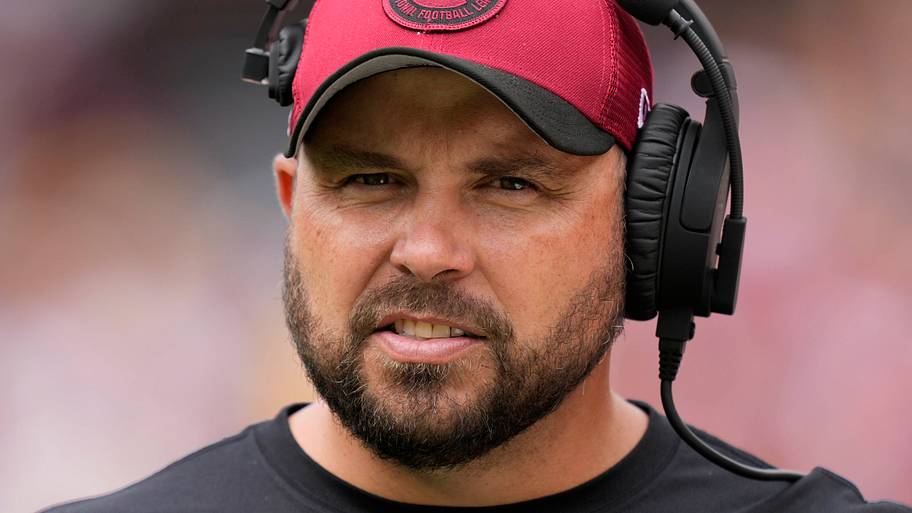 Arizona Cardinals offensive line coach Klayton Adams walks on the sideline before the game against the Washington Commanders