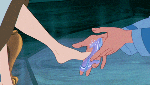 An animated prince places a glass slipper on Cinderella's foot, a classic story moment