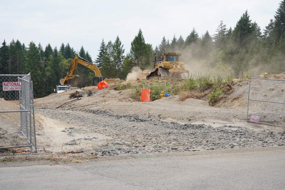 Excavators digging at the future site of Timberwalk Apartments near Canterwood Boulevard and Baker Way Northwest on Monday, July 20, 2026, near Gig Harbor, Wash.