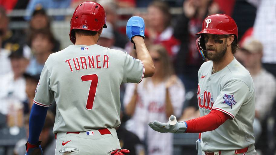Philadelphia Phillies first baseman Bryce Harper (right) greets shortstop Trea Turner after scoring run.