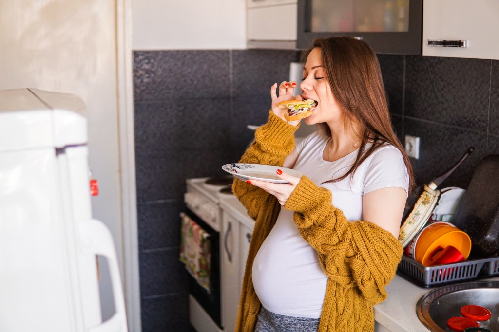 hungry-pregnant-girl-craving-food-135099530