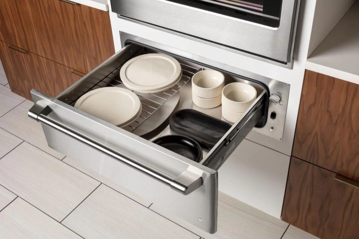 An oven warming drawer holding plates.