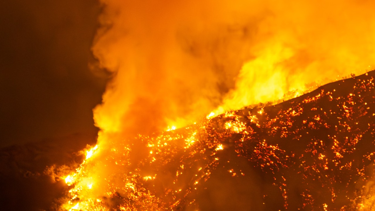 A fast-moving wildfire jumped the California-Nevada line and forced evacuations