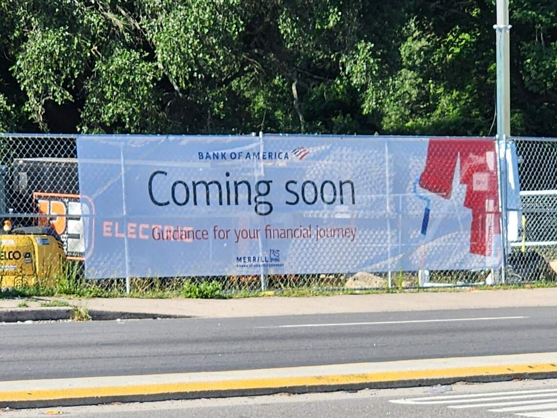 A banner announces that Bank of America is coming soon at 2525 Augusta Road in West Columbia, SC. Photographed on July 20, 2026.