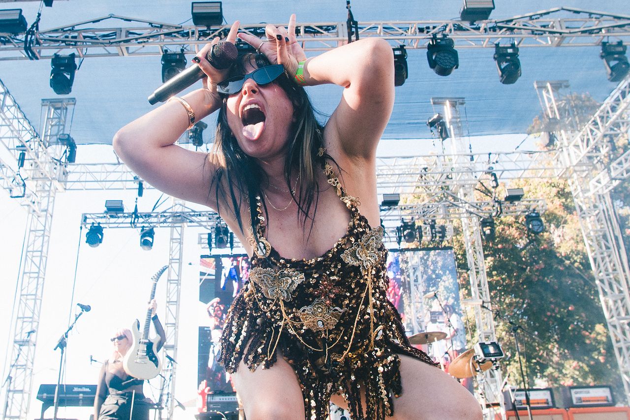A performer on stage during a live music event dynamic pose and energetic expression