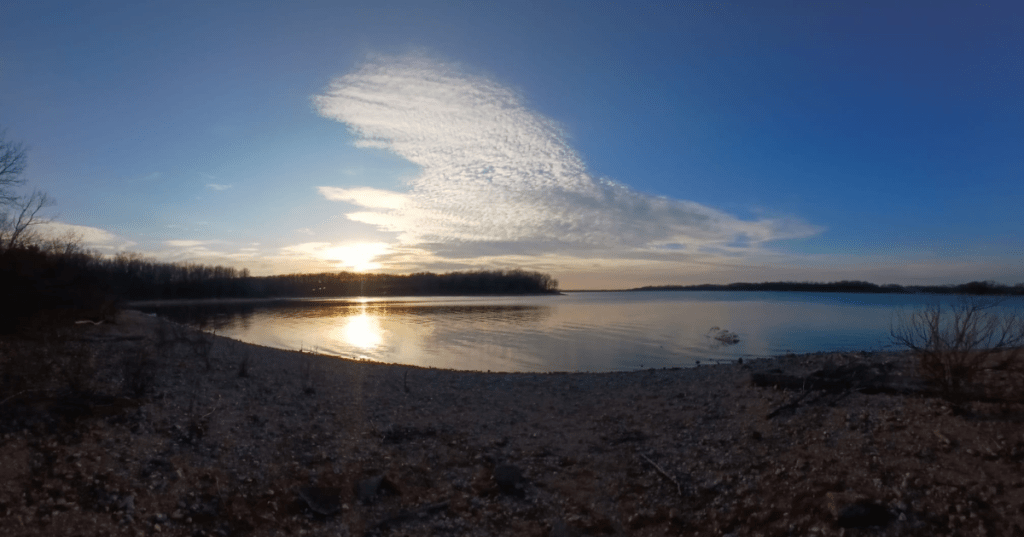 Vibrant sunset reflecting over the peaceful waters of Fellows Lake in Springfield, Missouri.