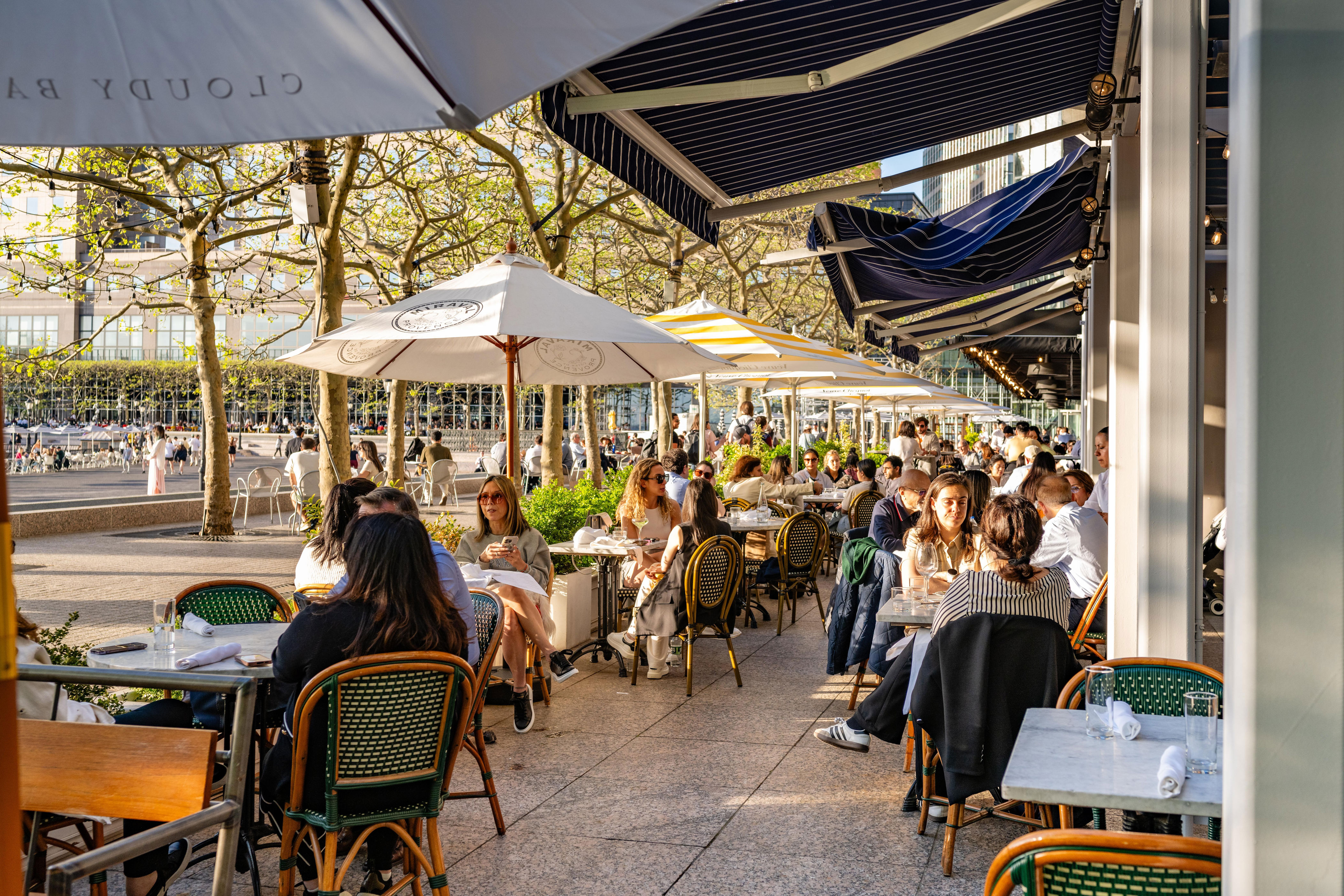 A sidewalk cafe outside of a restaurant.