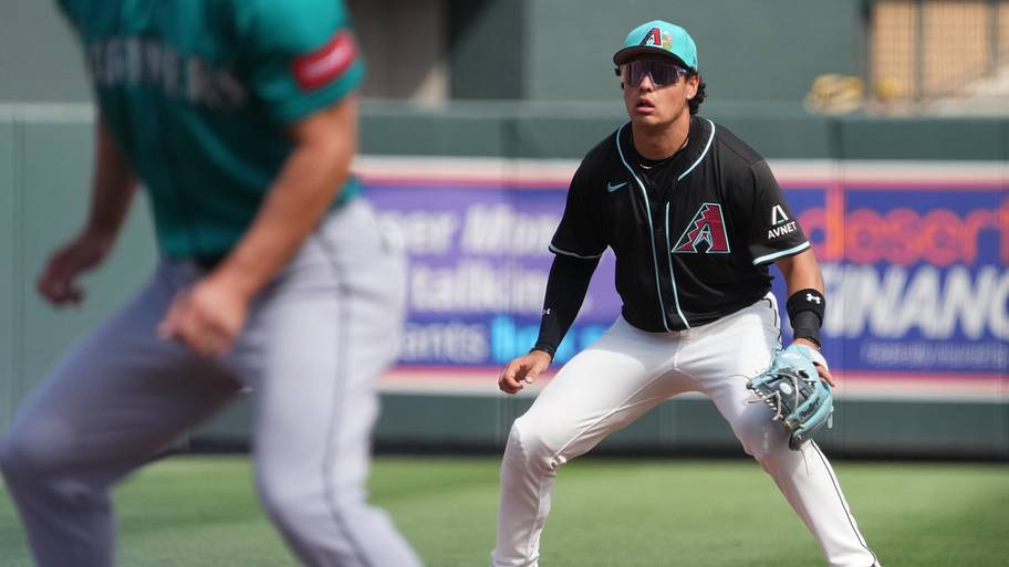 Arizona Diamondbacks infielder Demetrio Crisantes (5) tracks a pop-up against the Seattle Mariners at Salt River Fields