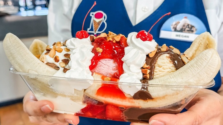 Employee holding a Braum's banana split
