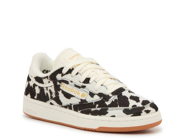 Cow-print sneakers with a low-top design, featuring the Reebok logo, suitable for casual wear