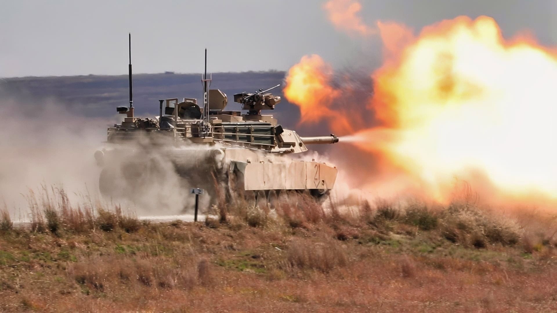 An M1A1 Abrams tank operated by Soldiers with the 2nd Battalion, 70th Armored Regiment, 2nd Armored Brigade Combat Team, 1st Infantry Division, fires while moving at the Douthit Gunnery Complex on Fort Riley, Kansas, Oct. 19, 2022. The tank crew was conducting gunnery for qualification. (U.S. Army photo by Sgt. Jared Simmons)
