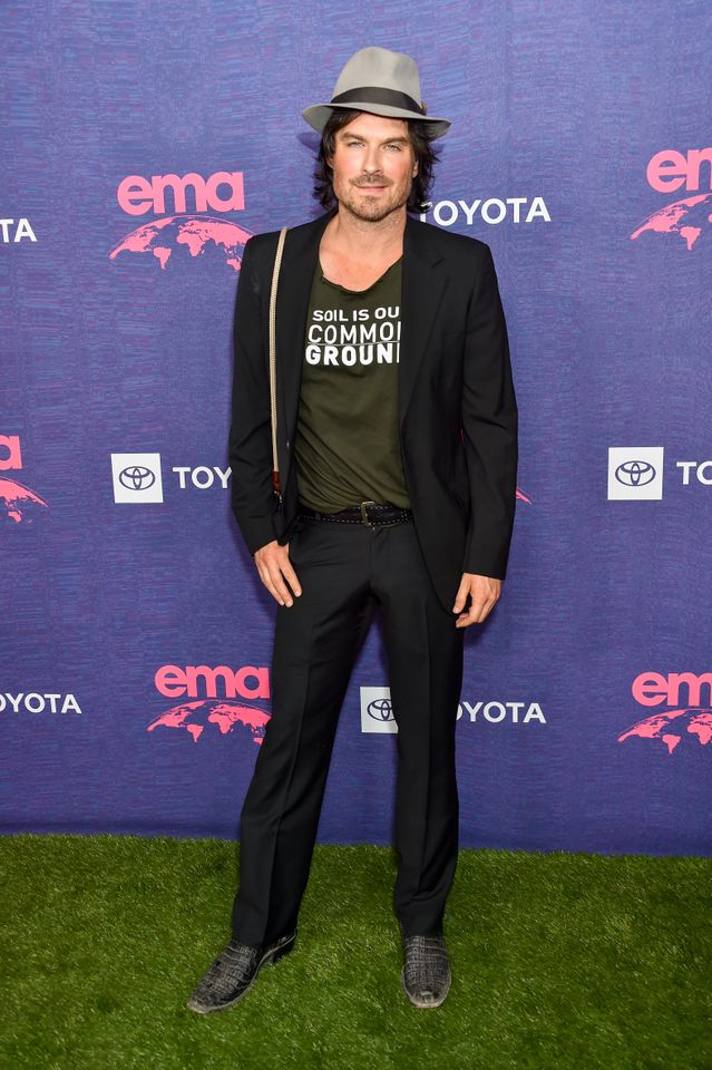Ian Somerhalder standing on a green carpet at an event with a blue background branded with EMA and Toyota logos