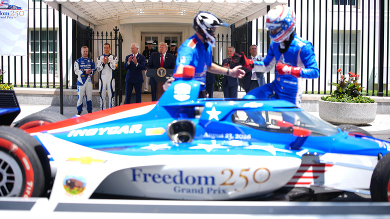 WASHINGTON, DC - JULY 13: U.S. President Donald Trump speaks as (L-R) 2026 Indianapolis 500 winner Felix Rosenqvist, reigning IndyCar series champion Alex Palou, Freedom 250 Grand Prix Chairman Bud Denker look on at a Freedom 250 Grand Prix showcase on West Executive Avenue between the West Wing of the White House and the Eisenhower Executive Office Building on July 13, 2026 in Washington, DC. The IndyCar Freedom 250 Grand Prix car race, August 22 and 23 on the National Mall, is part of America's 250th anniversary celebrations. (Photo by Andrew Harnik/Getty Images)