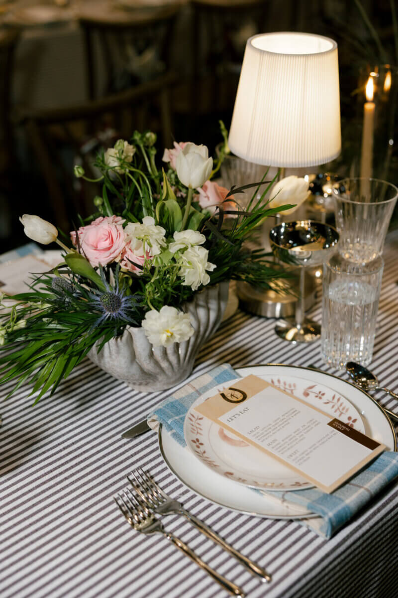 Claire put a lot of love into every detail of the tablescape design, from the branded wooden menus to the custom table lamps and dinnerware selections, including vintage-style glassware and silver coupes. Image: Rachel Fugate Photography