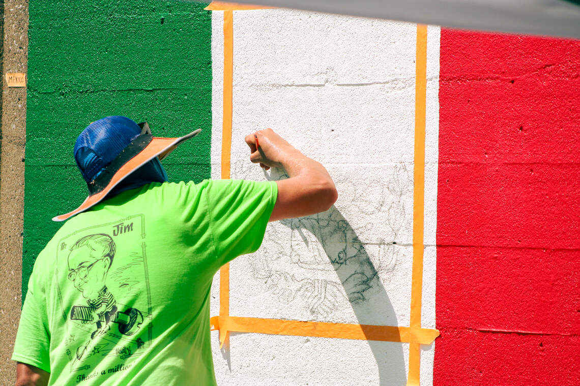 The Mexico flag is being repainted at the mural at Van Brunt between 9th and 12th street.