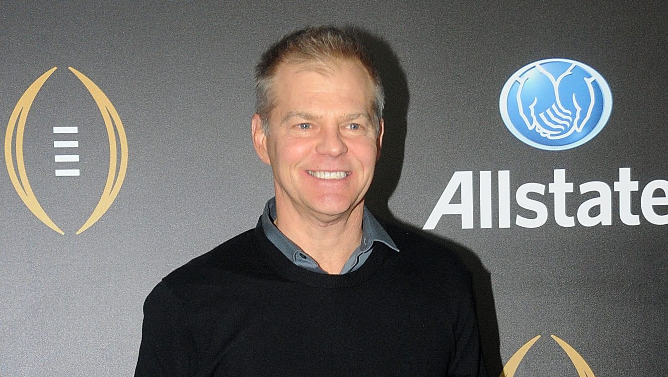 David Lloyd smiles on the blue carpet at ESPN's Party at the Playoff event, a look at the veteran anchor reportedly heading for the exit at the network.