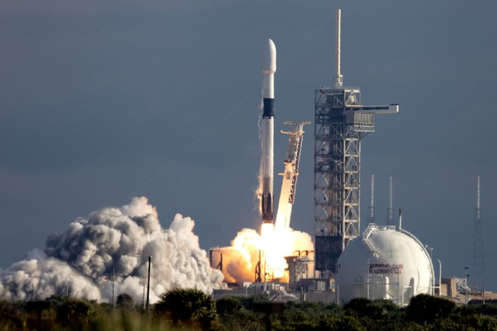 A rocket is lifting off of a launch pad.