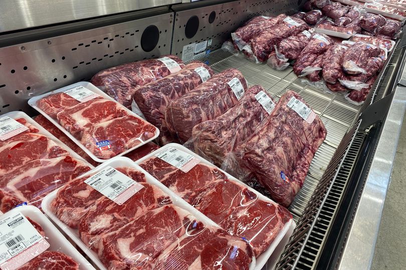 Meat butcher section of Costco store, with beef ribeye and London broil packaged meat, Florida.