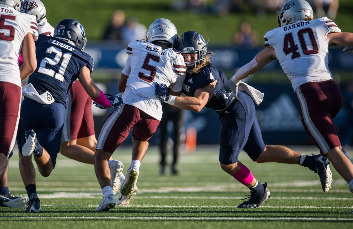 UC Davis Aggies defensive back Rex Connors (4), right, makes impact with Montana Grizzlies wide receiver Junior Bergen (5) during the second quarter of the NCAA college football game Saturday, Oct. 7, 2023, at UC Davis Health Stadium.