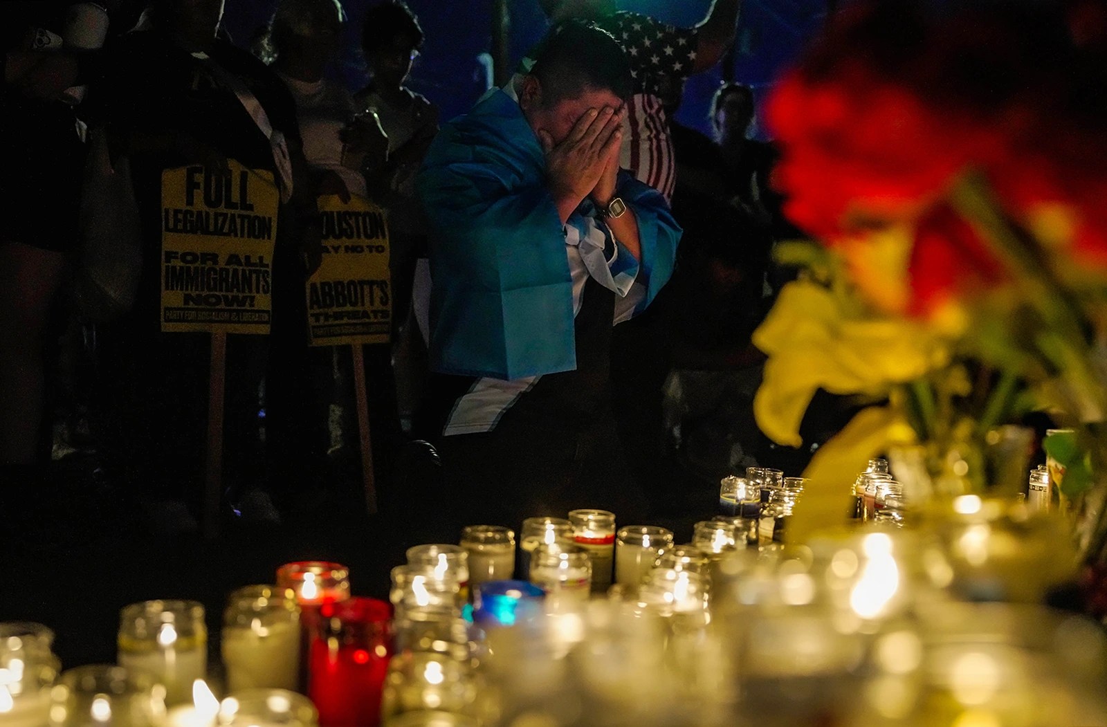 A person prays and weeps during a candlelight vigil for Lorenzo Salgado Araujo on July 8, 2026, in Houston, after a federal agent shot and killed Araujo.