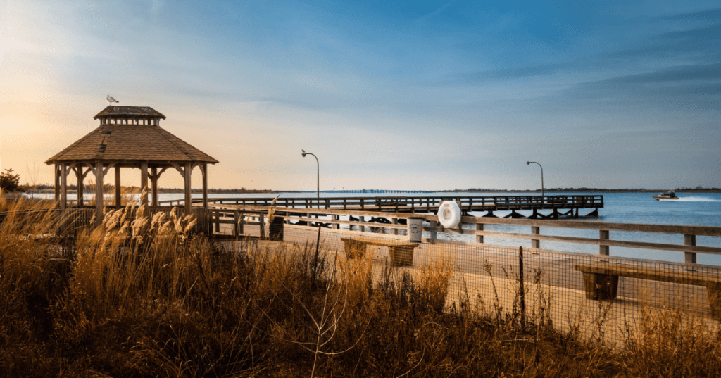 The Jones Beach Boardwalk at sunset, with a gazebo and fishing pier in view.
