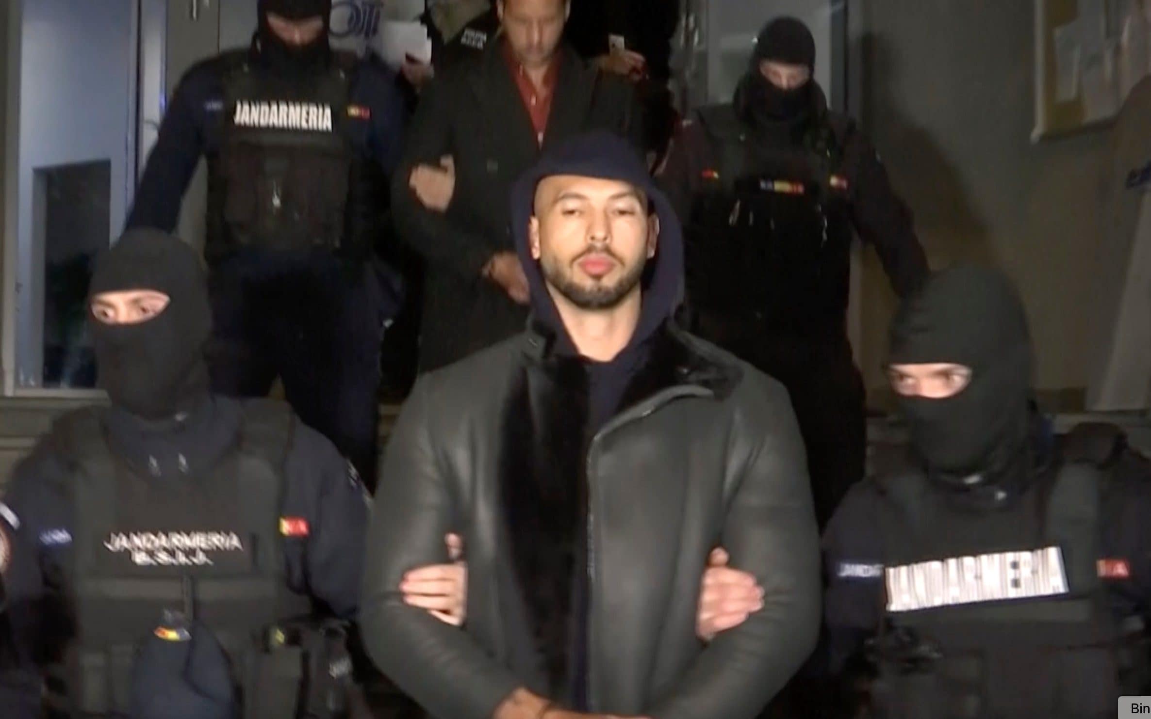 A grab taken from a video released by Observator Antena 1 showing Andrew Tate being led away by Romanian police in December 2022