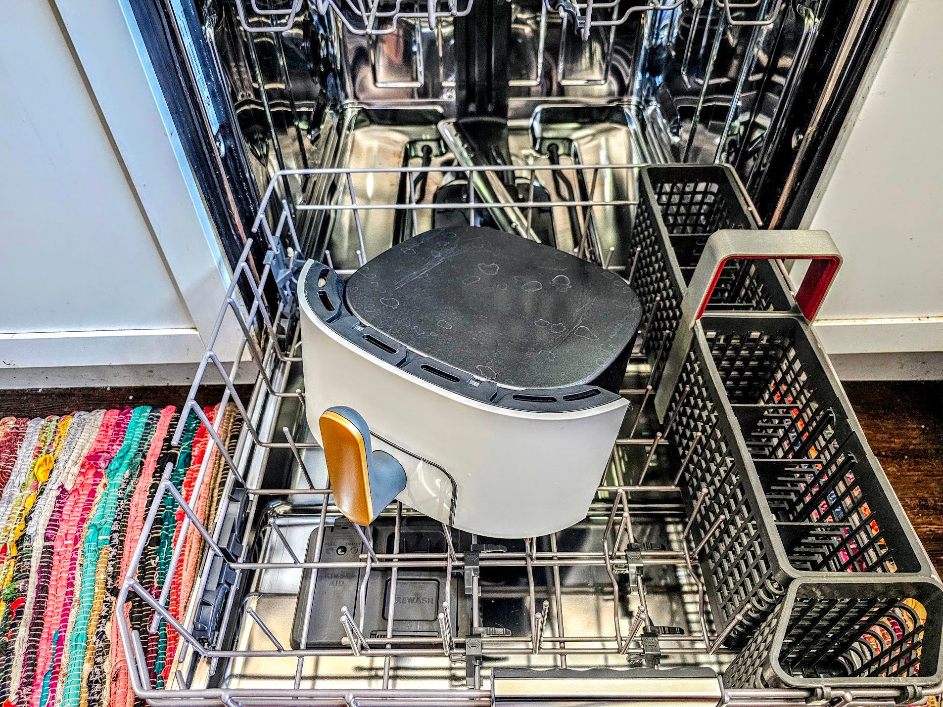 The basket of the Beautiful air fryer is displayed in the bottom rack of a dishwasher.