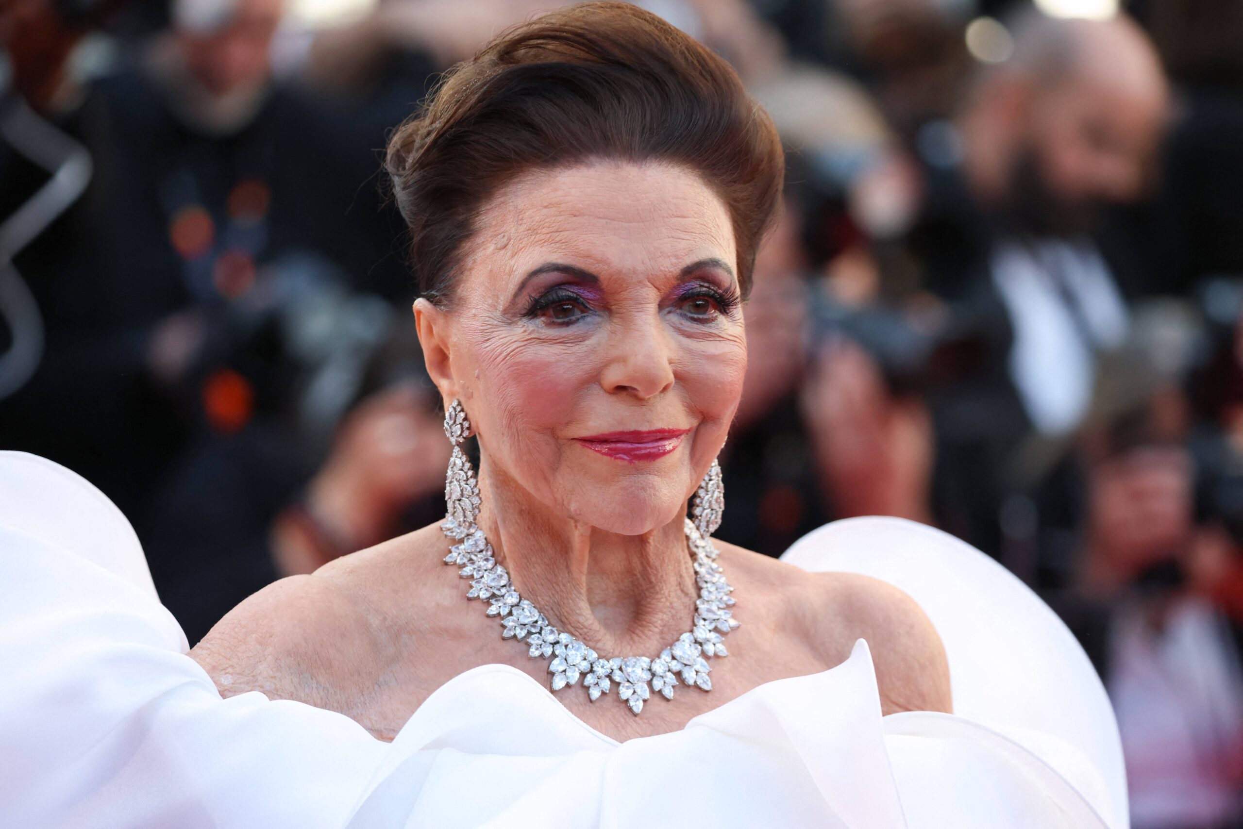 Joan Collins, 93, shields her face during pool day after declaring she doesn’t get any tweaks done