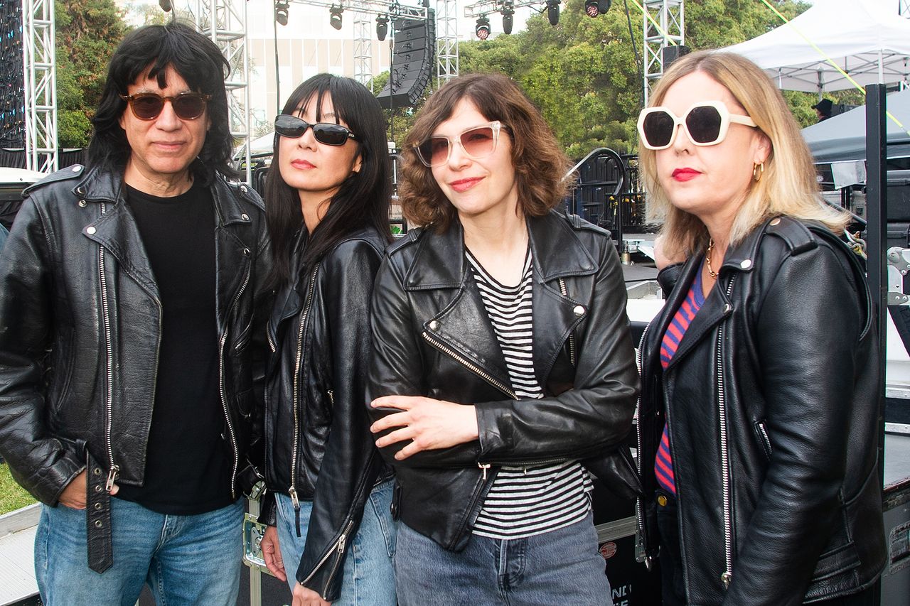 Corin Tucker Carrie Brownstein and Fred Armisen in leather jackets outdoors at an event