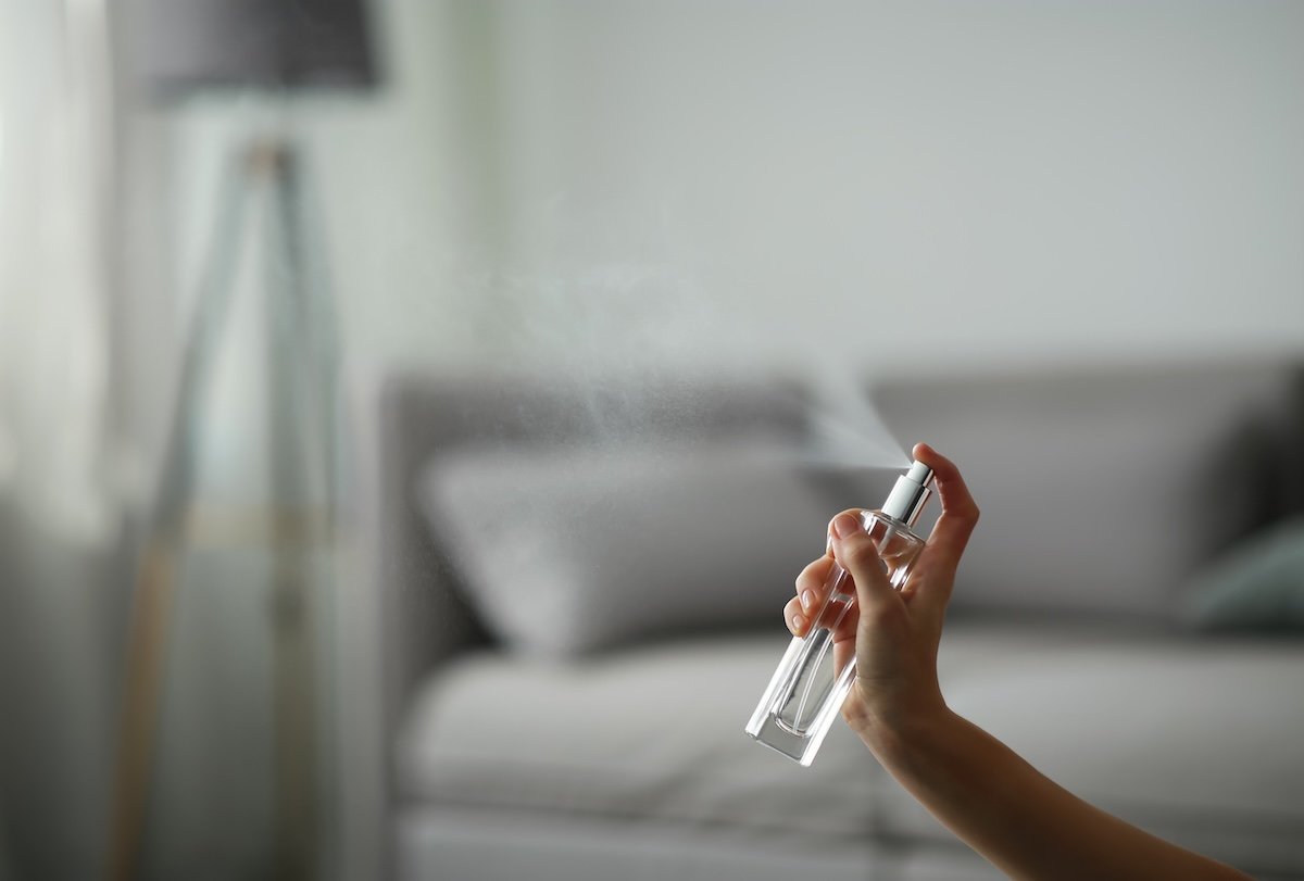 A person sprays an air freshening solution made with rubbing alcohol.