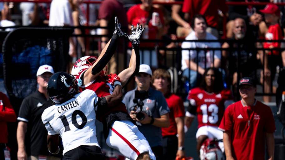 Cincinnati Bearcats defensive back Derrick Canteen (10) defends as Miami Redhawks wide receiver Kam Perry (10) catches a pass