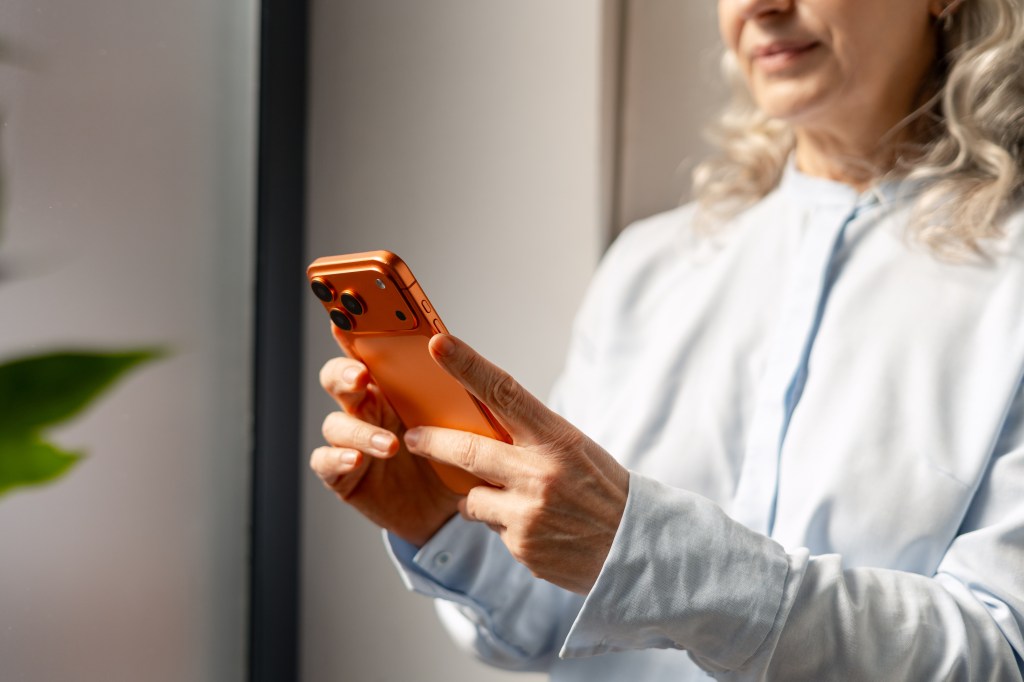 Senior woman using smartphone for digital connection and mobile application access