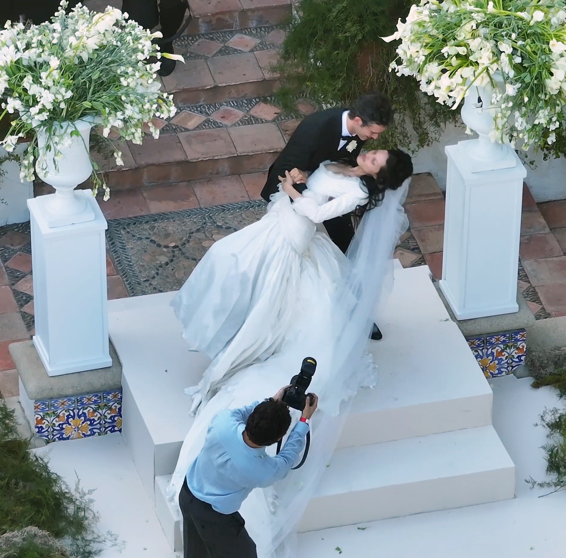 Matty Healy dips and kisses his bride Gabbriette Bechtel at their wedding.