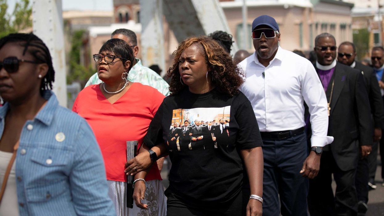 LaTosha Brown, founder of Black Voters Matter, marches across the Edmund Pettus Bridge during the National Day of Action. Alyssa Pointer/ Reuters)